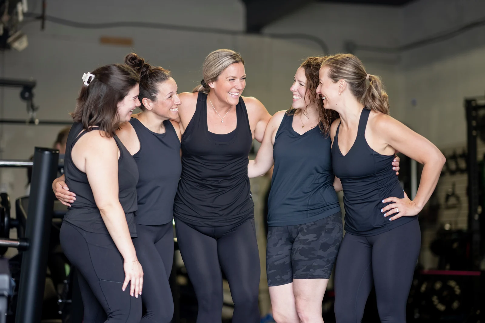 Members of the KLT Fit community laughing together in the studio