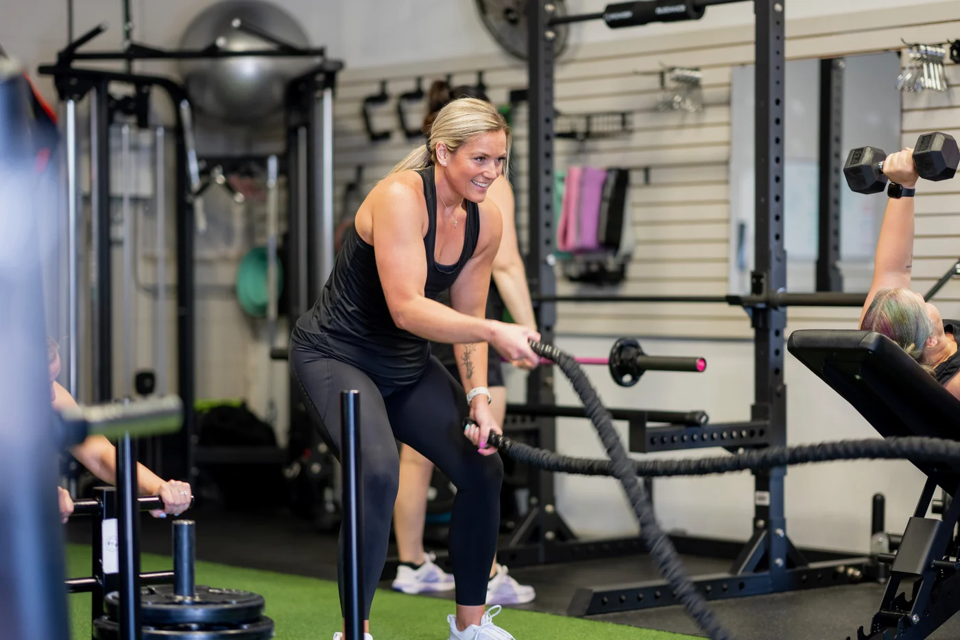 Kate, founder and transformation coach at KLT Fit, working the battle ropes during a session
