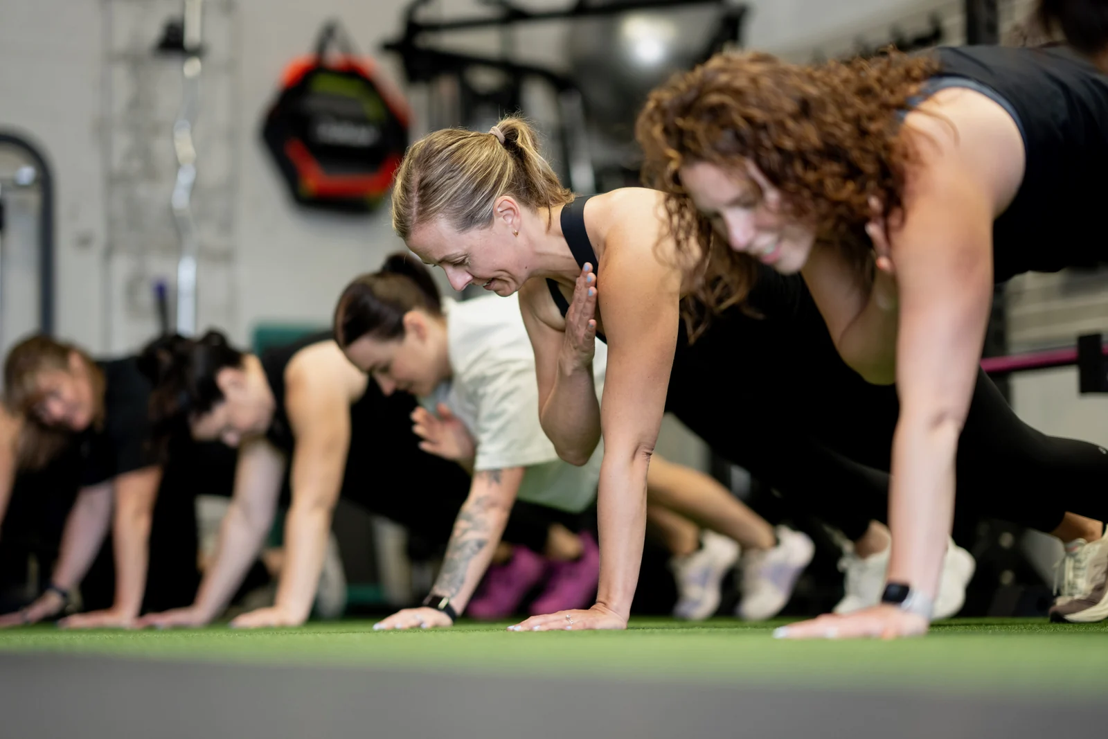 A small group class working through a floor set together on the turf inside the KLT Fit studio in Peterborough